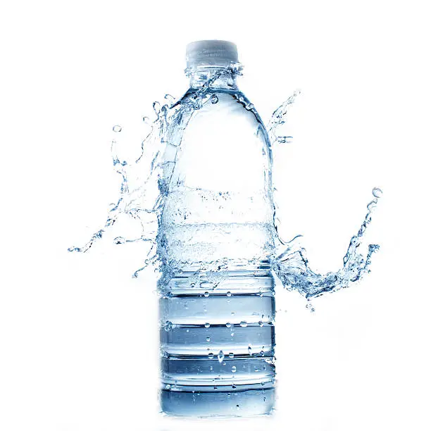 Photo of Water splashing onto full plastic water bottle