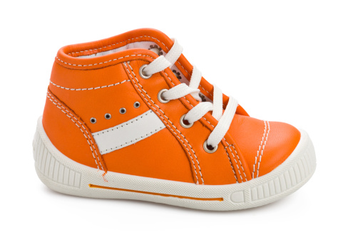Orange baby shoe isoaletd on white