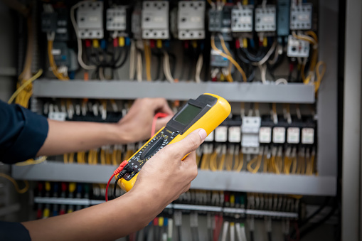 Sample Electrical Meter Testing Program Engineer Testing Electrical System Using A Multimeter To Measure The ...