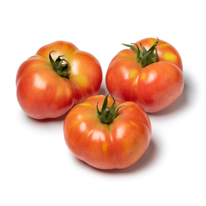 Three whole Galapagos tomato isolated on white background close up