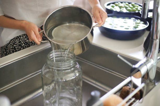 istock A woman sterilizing a bottle with boiling water 1702406433