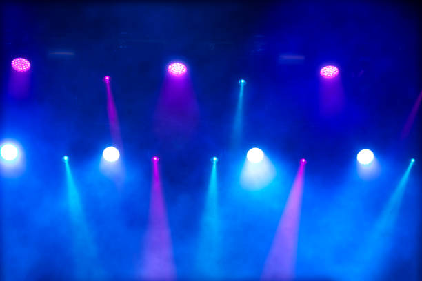 istock Bright multi-colored iridescent lights of stage lighting. Background scene, performance. Concert light. 1702408705