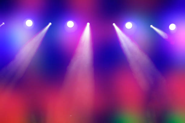 istock Bright multi-colored iridescent lights of stage lighting. Background scene, performance. Concert light. 1702408706