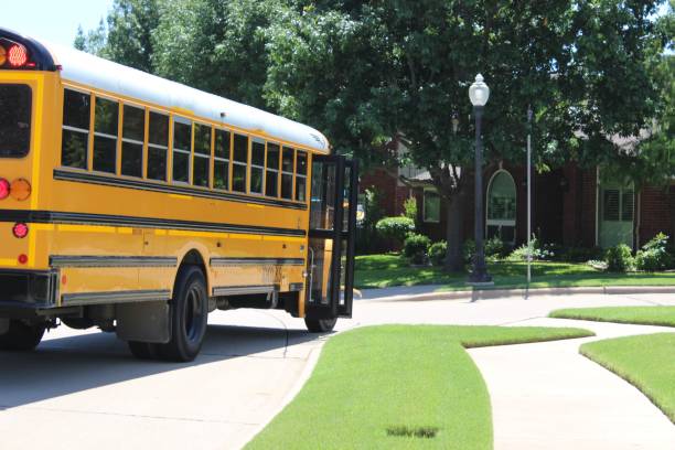 istock Yellow public school bus at the bus stop to drop off students 1702460281