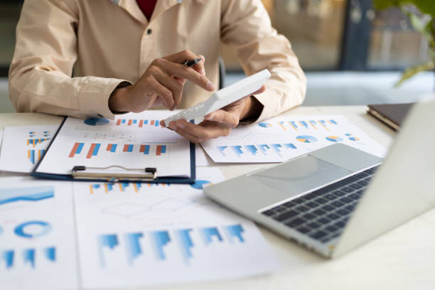 istock Businessman pointing at financial chart document and statistical market growth analysis. Accounting concepts and financial planning for investment. 1702464308