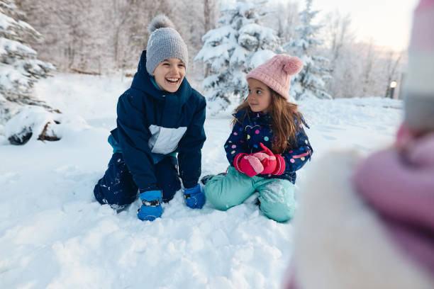 istock Happy kids enjoying winter snow 1702472066