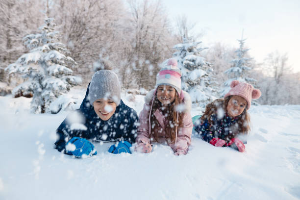 istock Happy kids enjoying winter snow 1702474448