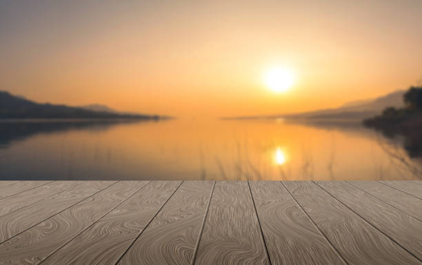 istock Wood shelf perspective sunset gold hour landscape light background 1702480991