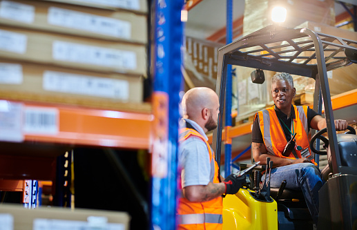 female fork lift driver in a warehouse