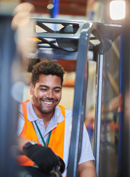 istock fork lift truck driver in a warehouse 1702484888