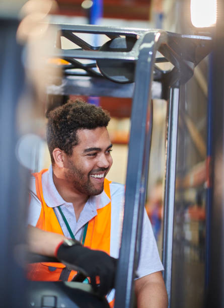 istock fork lift truck driver in a warehouse 1702486027