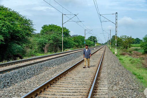 Pune, India - September 24 2023: Man walking on railway tracks near Pune India.