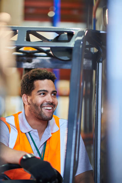 istock fork lift truck driver in a warehouse 1702487126