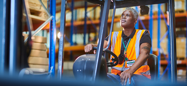 female fork lift operator loading