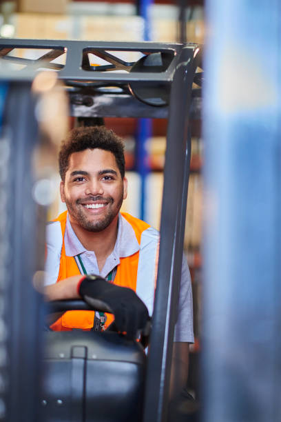 istock fork lift truck driver in a warehouse 1702488781