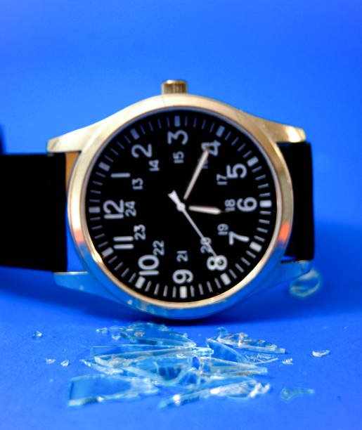 Watch with screen glass cracked on blue background