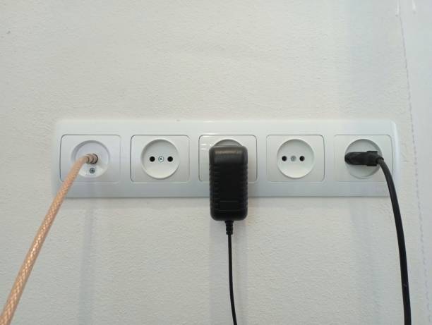 istock A home panel with electrical sockets and TV cable is built into the wall in a large color. Two devices and a cable are included in the outlet. 1702491461