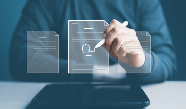 istock Electronic signature, e-signing, document lean management, paperless office. Businessman signing digital document on a tablet with virtual screen. Online business contract agreement with application. 1702492191
