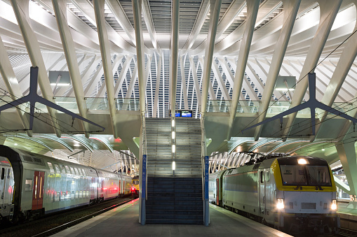 Passenger trains in a futuristic railroad station, Liege, Guillemins, Belgium.