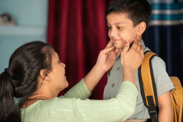 istock Indian mother preparing her son for school. 1702493781
