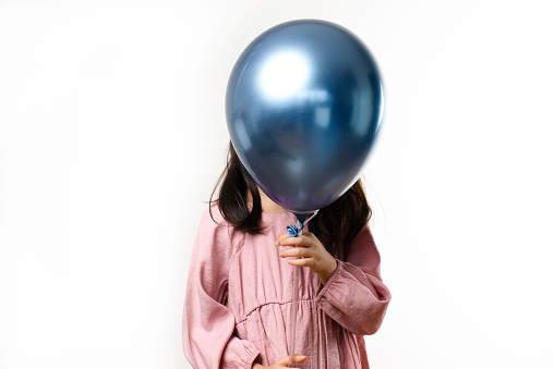 Girl is holding balloon.
