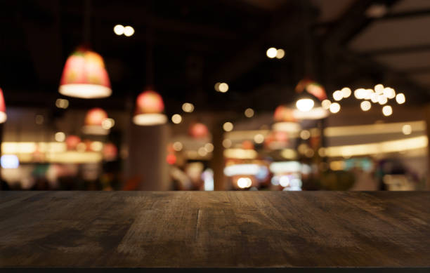 istock Mock up for space. Empty dark wooden table in front of abstract blurred bokeh background of restaurant . can be used for display or montage your product 1702507068