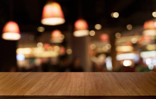 istock Mock up for space. Empty dark wooden table in front of abstract blurred bokeh background of restaurant . can be used for display or montage your product 1702507374