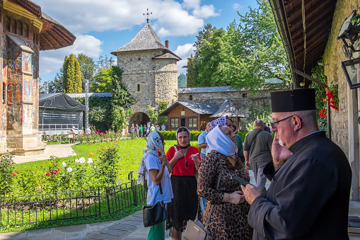 Bucovina, Romania - September 10, 2023: Orthodox priest and parishioners inside the Moldovita monastery