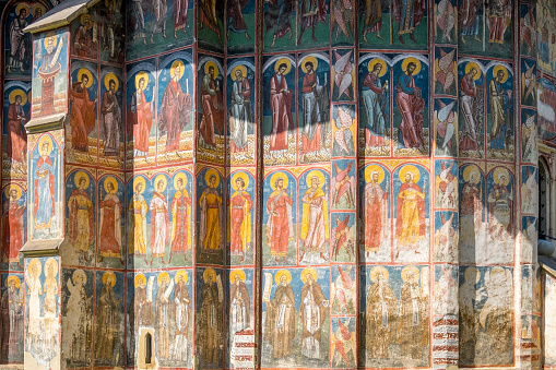 Bucovina, Romania - September 10, 2023: Religious paintings on one of the exterior walls of the Moldovita Monastery church