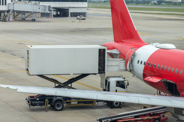 Loading cargo on the plane in airport. Process of cargo handling. Parcels loading with high loader at Airport. Preparation of the airplane before flight. Upload equipment for flight