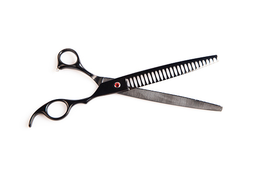 Stainless steel hair thinning scissors on white background