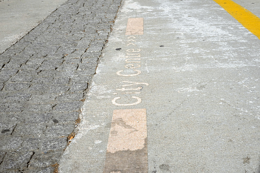 Pavement with an inscription City Centre and tripple arrow showing the direction where to go.