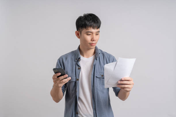 istock Man using calculator to calculate overdue debt bills. 1702539911