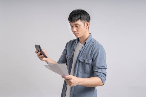 istock Man using calculator to calculate overdue debt bills. 1702540967