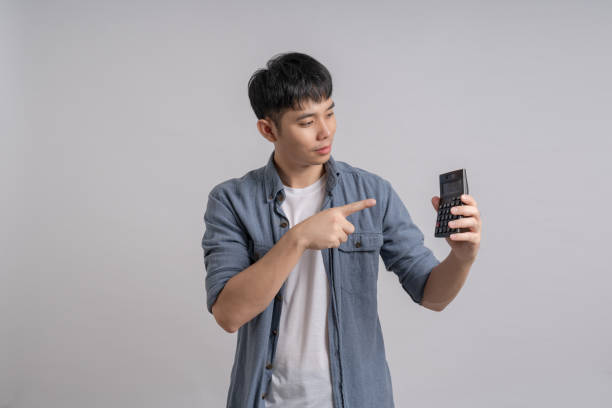 istock Man holding calculator with smiling happily. 1702542074