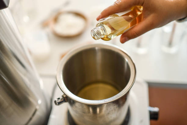 istock Woman pouring scent for candles, manufacturing process 1702542609
