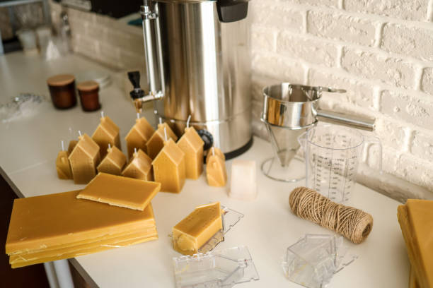 istock Beeswax candles. Process of making candles in a workshop 1702544861