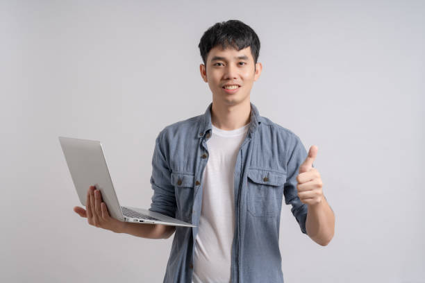 istock Man holding computer laptop and celebrating with happy smile. 1702548811
