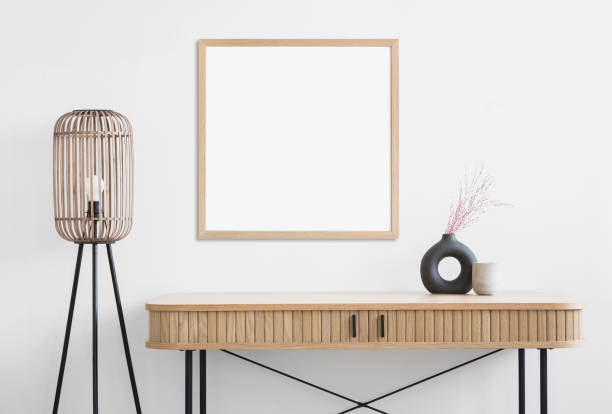 Artwork mockup in interior design. Blank picture frame on a wall. Square orientation