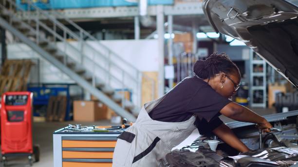 istock Coworking mechanics fixing car 1702568444