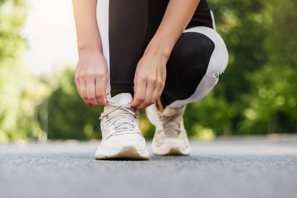 istock Close up of young woman getting ready for jogging 1702570613