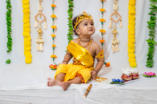 adorable infant dressed as hindu god krishna on the occasion of janmashtami celebrated at india
