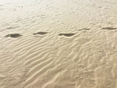 Footprints in the sand background with copy space great for vacation adverts