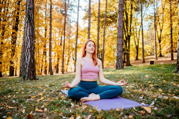 istock Beautiful woman practicing Yoga in nature 1702590121
