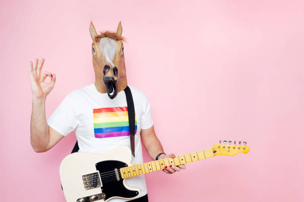 istock Man with horse mask and electric guitar 1702608525