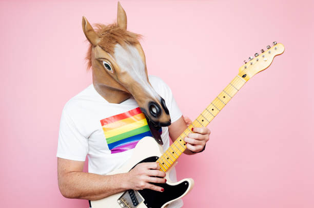 istock Man in a horse mask playing electric guitar. 1702608535