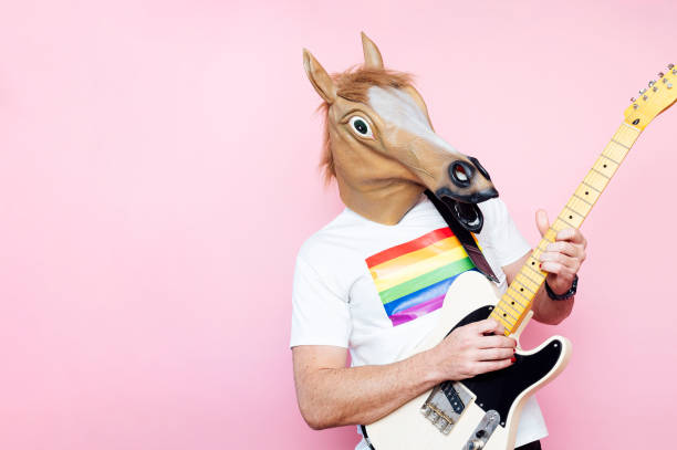 Man in a horse mask playing electric guitar.