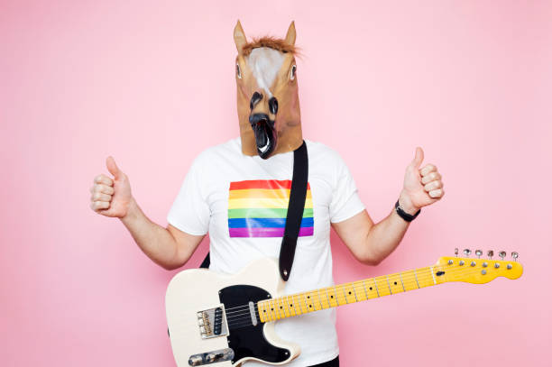 istock Man with euphoric horse head and fingers up. 1702609076