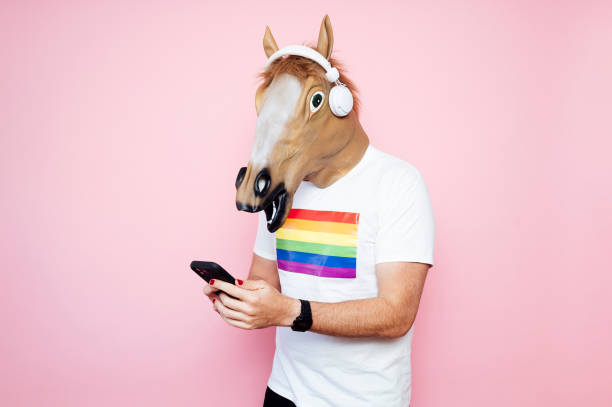 istock Man in a horse mask playing electric guitar. 1702610185