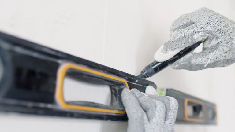 Construction worker using leveling tool during interior decoration/reconstruction